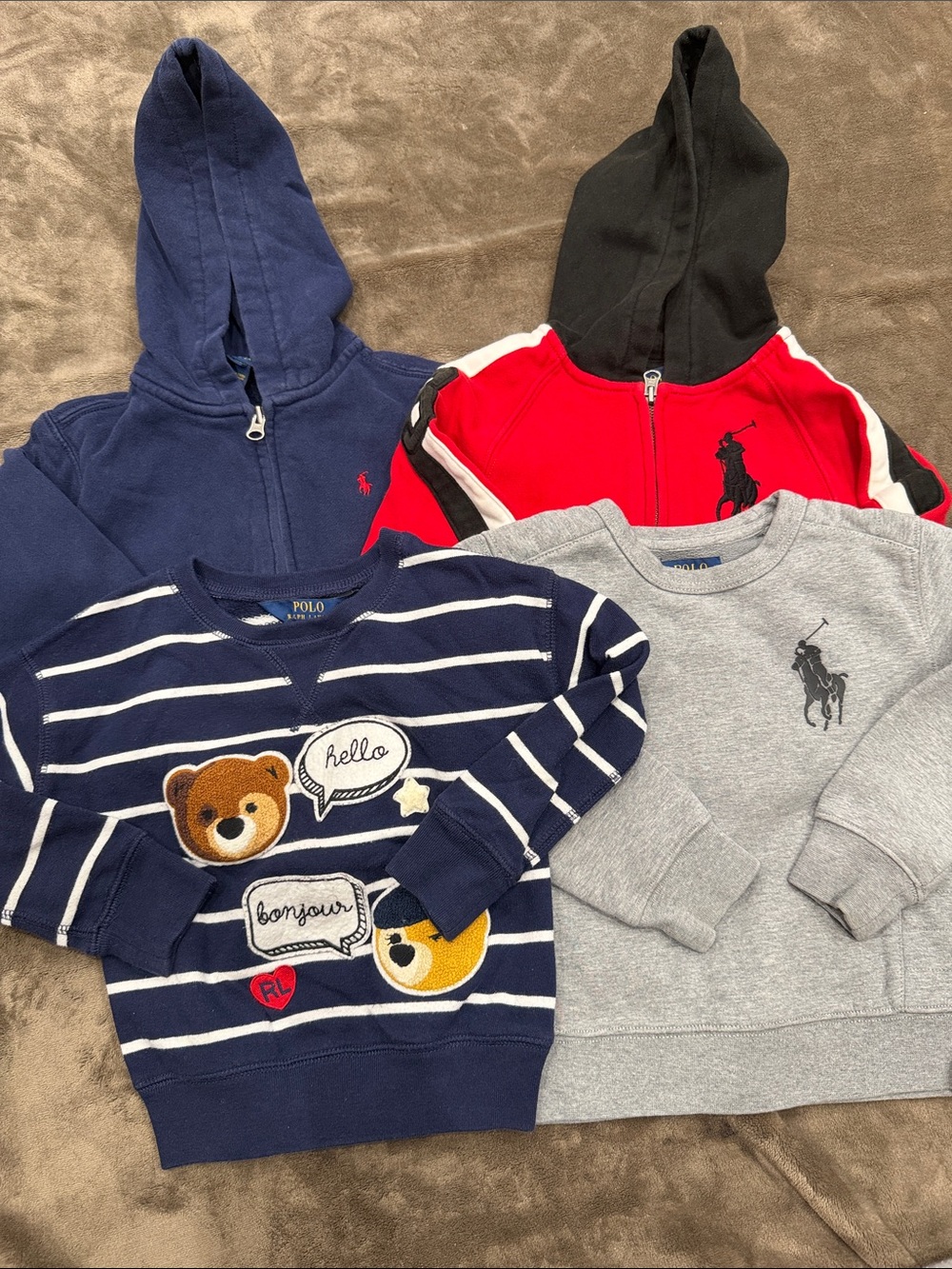 4 Ralph Lauren Sweatshirts and hoodies with different designs.